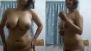 A curvy Indian woman with blonde hair flaunts her large breasts and intimate area