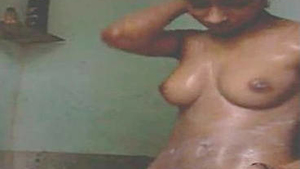 Naked Desi beauty in the bathtub grabs and grinds