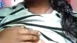 A seductive woman unveils her large breasts in a sizzling video