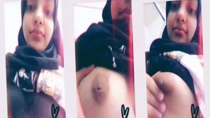 Young hijabi woman reveals her ample bosom on camera