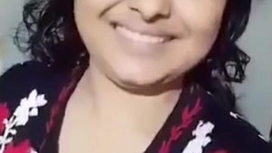 A married woman from Bangladesh with large breasts pleases her husband by posing for him
