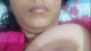 A sultry Desi woman entices with her ample breasts and intimate area