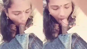 A woman of South Asian descent performs oral sex on her African American partner in a public setting.