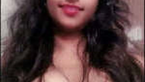 An Indian woman proudly displays her large breasts