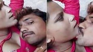 Young Desi woman is lying in bed with lover kissing her on camera