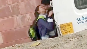 Amateur Indian teens kiss passionately in a college setting