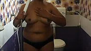 Fat Indian female with mask on her face performs porn showering